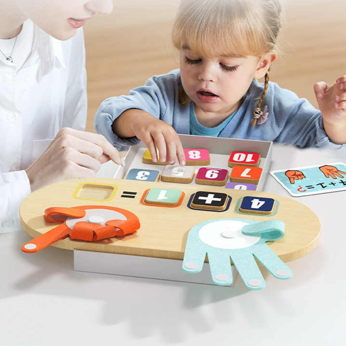 A young child and adult use a finger math toy with wooden number tiles and fabric hands with velcro fingers.