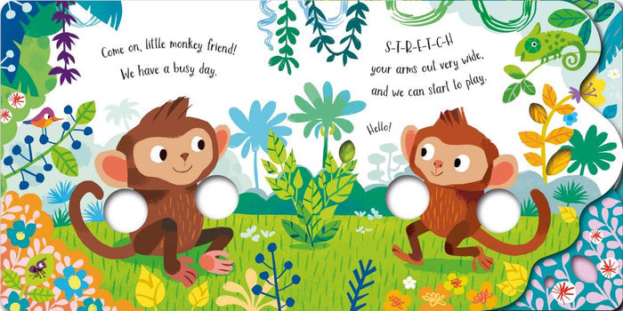 Colorful jungle board book spread with two monkeys and round finger cutouts in place of their arms.