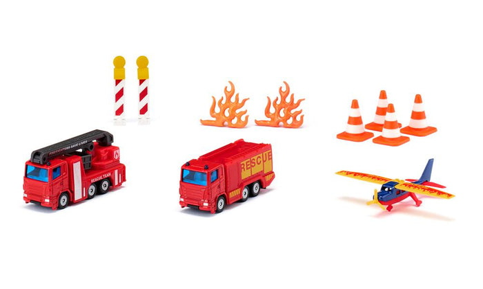 Two red fire trucks, a yellow and blue toy plane, orange traffic cones, plastic flames, and safety barriers.