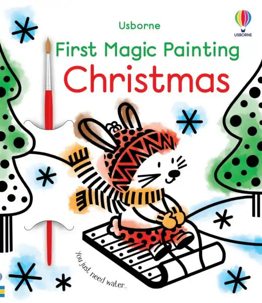 Cover of a Christmas activity book with an illustrated bunny on a sled, watercolor splashes, and a small paintbrush.