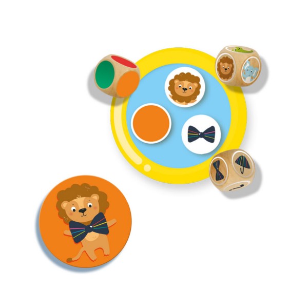 Three wooden dice, a yellow ring containing tokens, and an orange circular card of a lion wearing a bow tie.