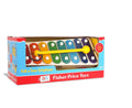 Toy xylophone with 8 rainbow-colored bars and a yellow mallet in its red and blue Fisher-Price display box.