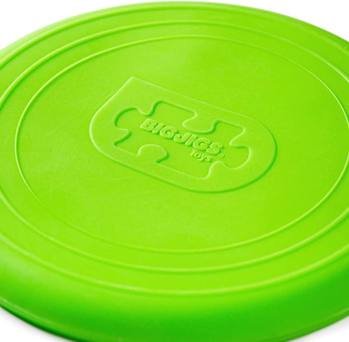 Bright green flexible flying disc with concentric rings and an embossed Bigjigs Toys logo in the center.