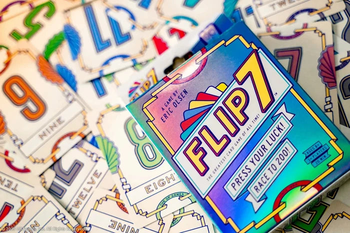 Teal Flip 7 game box with yellow text on a background of colorful, art deco-style number cards.
