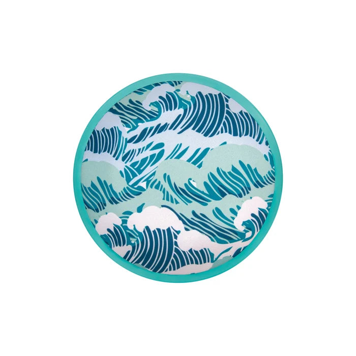 Circular turquoise flying disc with a blue and light green stylized ocean wave pattern on its fabric center.