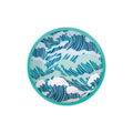 Circular turquoise flying disc with a blue and light green stylized ocean wave pattern on its fabric center.