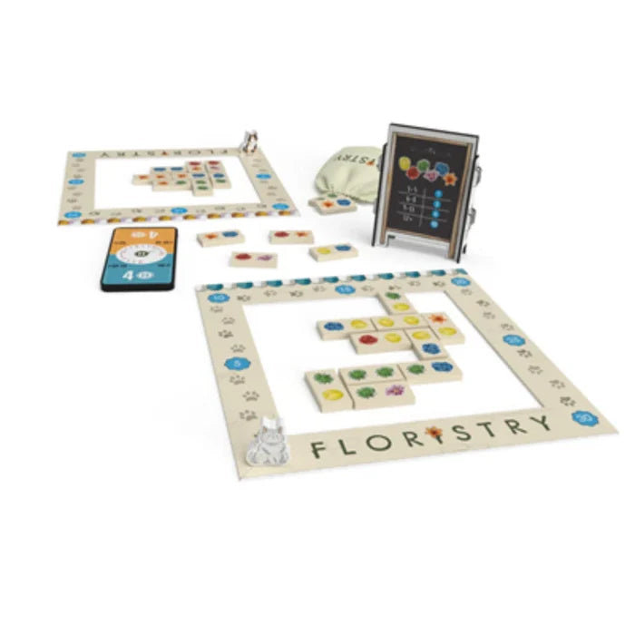 Floristry board game with white frame boards, colorful flower tiles, cat figurines, and a small scoreboard stand.
