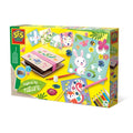 Yellow SES Creative box displaying a wooden flower press, colorful animal drawings, and a set of colored pencils.