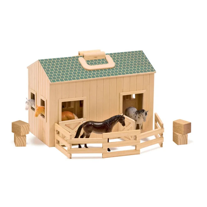 Wooden toy stable with green roof, carrying handle, fence, four horse figurines, and wooden hay blocks.