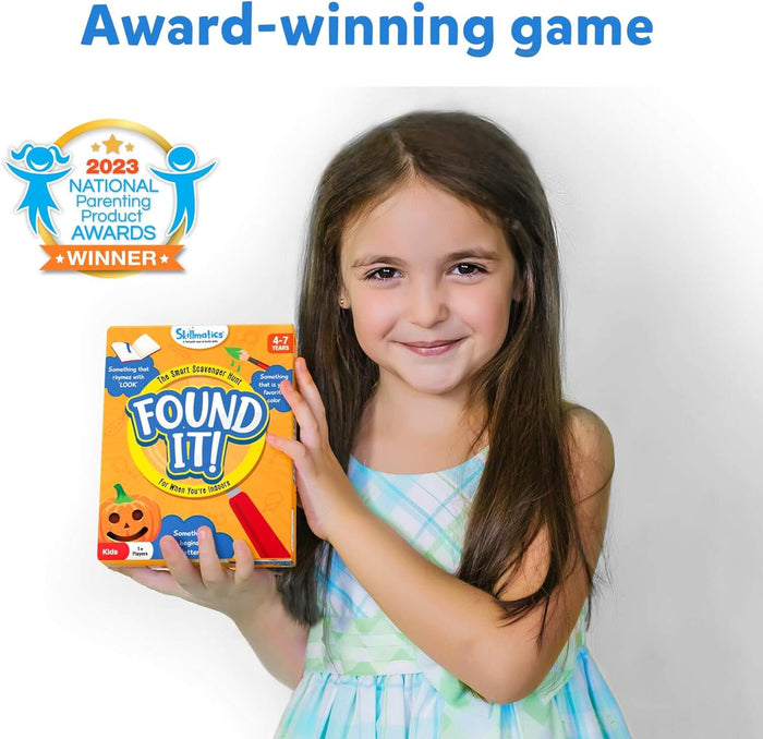 Young girl holding a colorful Found It! game box featuring scavenger hunt prompts and an award winner badge.
