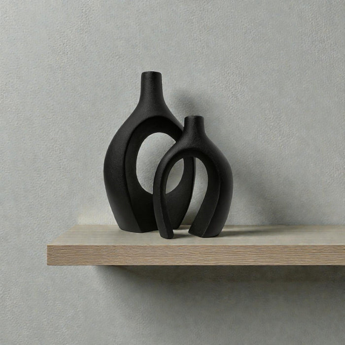 Pair of black ceramic sculptural vases with arch and sitch designs from Nest & Stem Homewares, perfect for modern decor.