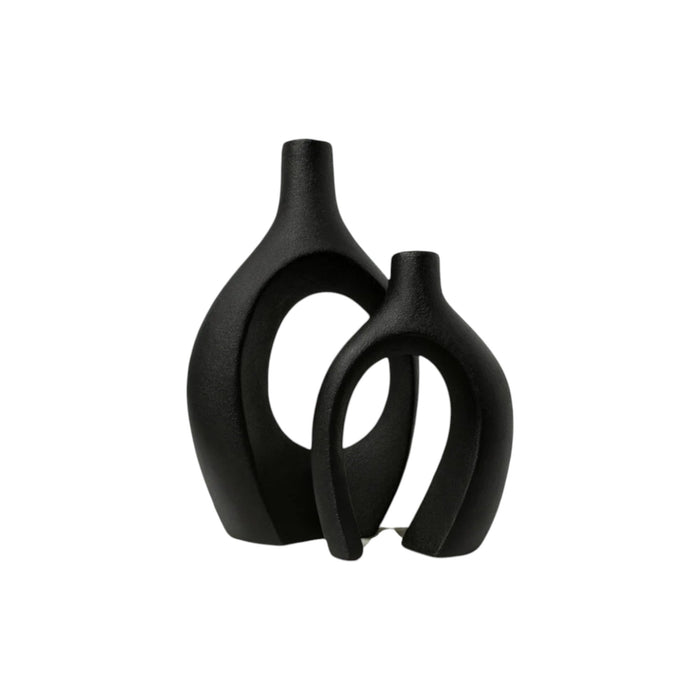 Set of two black ceramic vases with modern sculptural design by Nest & Stem Homewares on a white background.