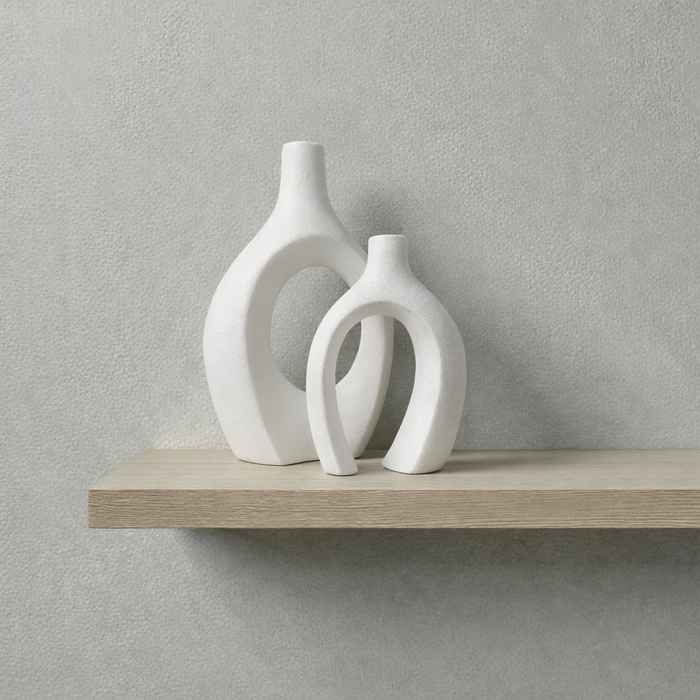 Set of two white ceramic sculptural vases by Nest & Stem Homewares, featuring modern black accents and artistic shapes.