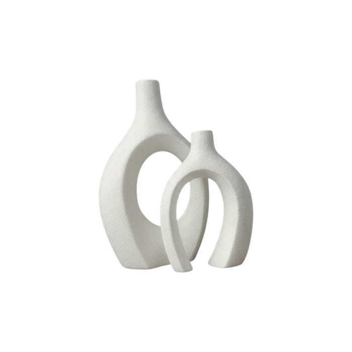 Set of two black ceramic sculptural vases with modern, abstract shapes from Nest & Stem Homewares on a white background.