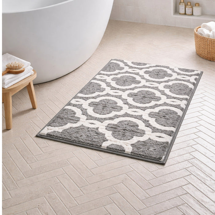 Nest & Stem Homewares Frankly Cotton Geometric Bath Mat with white and gray pattern on soft cotton surface.