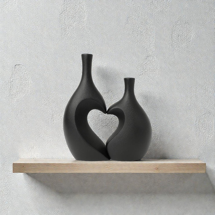 Pair of black ceramic vases featuring heart and unity design from Nest & Stem Homewares, ideal for home decor.