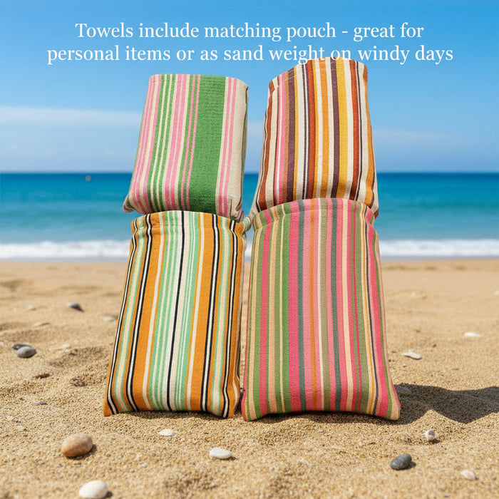Four colorful Frankly Cotton quick-dry beach towels by Nest & Stem Homewares, 100x180cm, laid out on the beach.