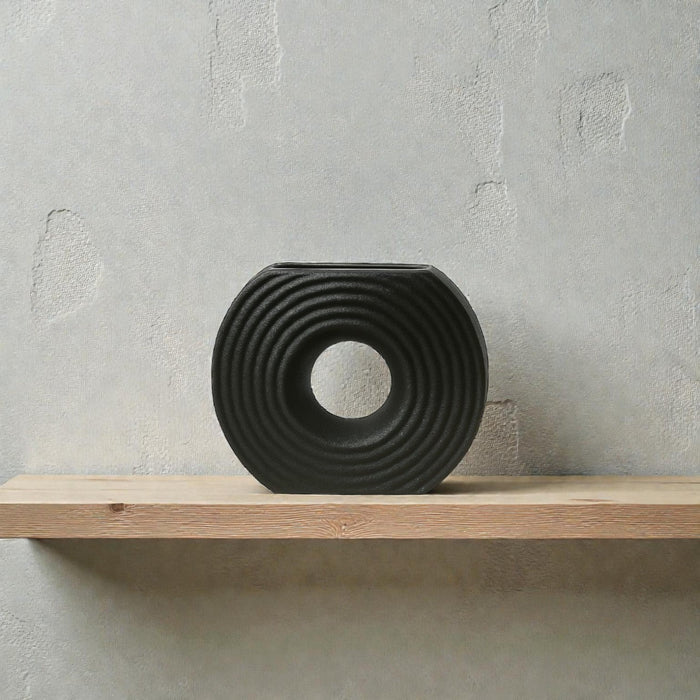 Black circular textured ceramic vase by Nest & Stem Homewares, featuring a sleek, modern design with a smooth finish.