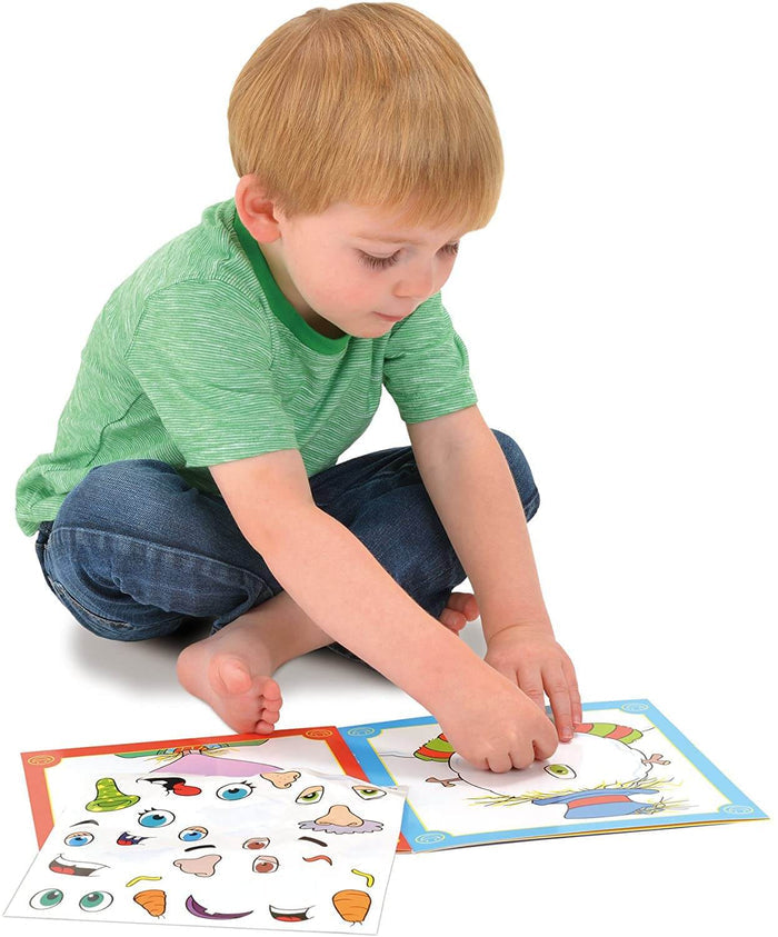 A child in a green striped shirt placing cartoon facial feature stickers onto an illustrated face template.