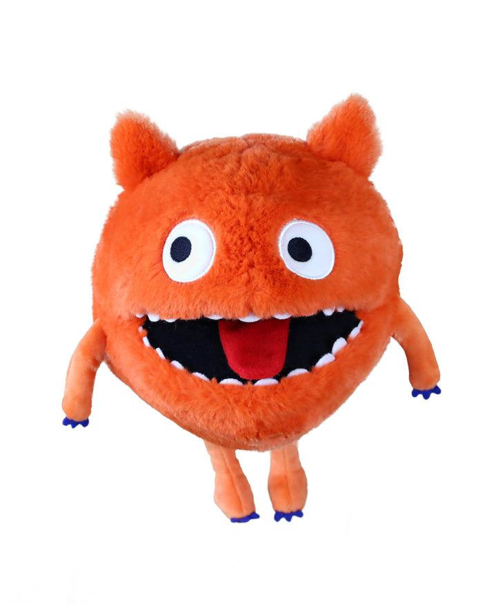 Fuzzy round orange monster puppet with large white eyes, wide open mouth, red tongue, and thin limbs with blue claws.