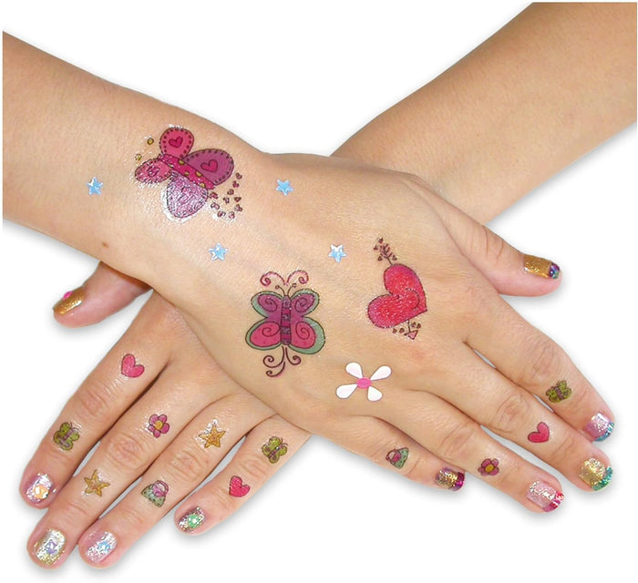 Hands with colorful butterfly and heart temporary tattoos and small decorative stickers on the fingernails.