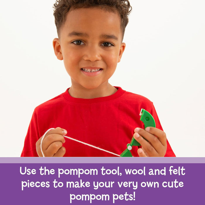 Smiling child in a red shirt using a green pompom maker and white wool, above a purple banner with white text.
