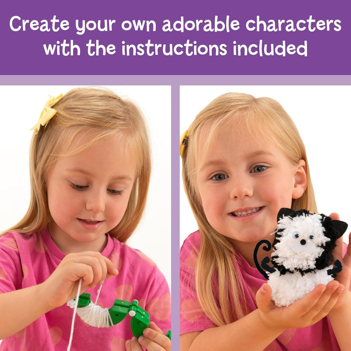 Girl using a green pompom maker and holding a finished black and white pompom cat with googly eyes.