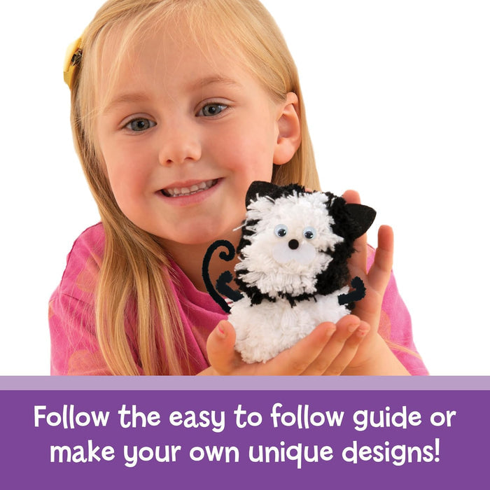 Young girl holding a black and white pompom kitten craft. Text: Follow the guide or make your own unique designs!