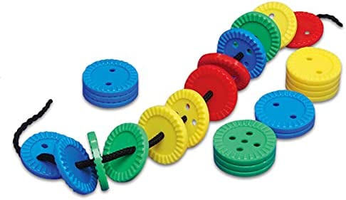 Brightly colored, round plastic buttons with ridged edges in blue, green, yellow, and red, some threaded onto a black cord.