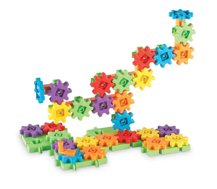 Colorful red, orange, yellow, green, blue, and purple interlocking gears built into a tiered tower on a green base.