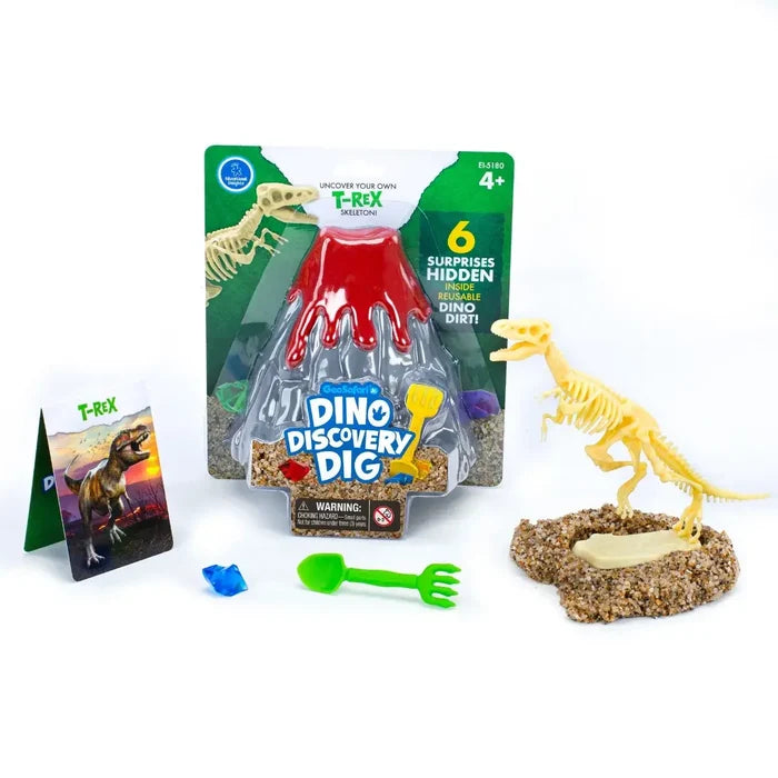 Dinosaur dig kit with volcano packaging, assembled T-Rex skeleton, sand base, green tool, blue gem, and fact card.