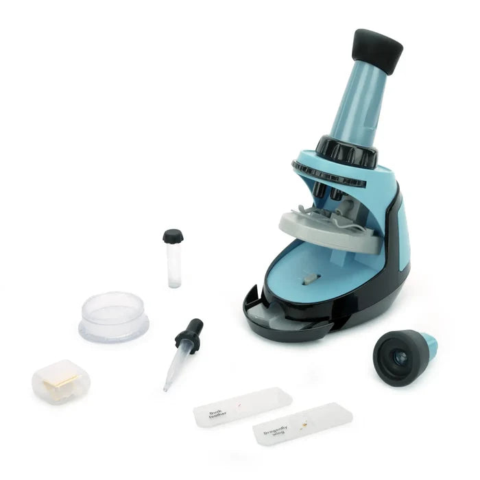 Blue and black toy microscope science set with prepared slides, pipette, and petri dish on a white background.
