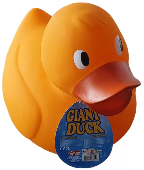 Large orange rubber duck with white eyes, dark orange beak, and a blue oval tag attached to its neck.