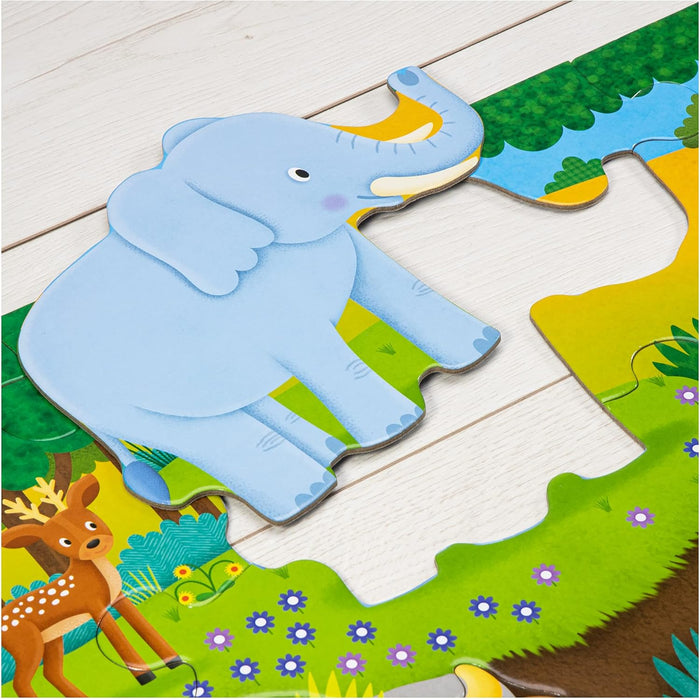 Large colorful puzzle pieces featuring a blue elephant and a brown deer on a light wood floor.