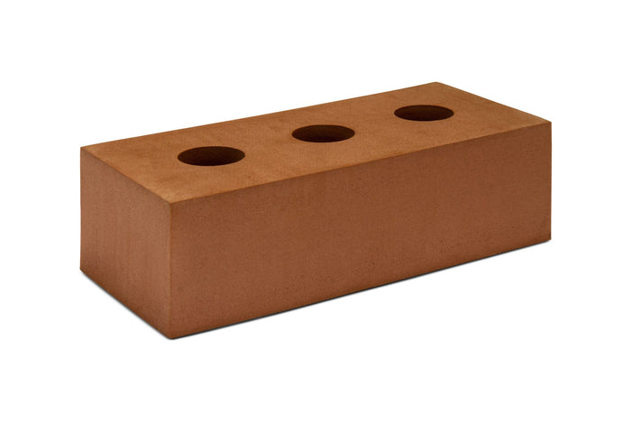 Rectangular reddish-brown toy block with three circular holes on the top surface.