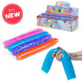 Colorful gel-filled water wrigglers in a display box. A hand bends a large blue tube to show its flexible texture.