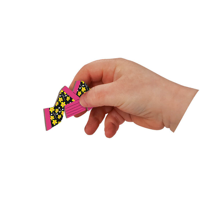 A hand holds a pink and black floral magnetic costume piece shaped like a kimono.