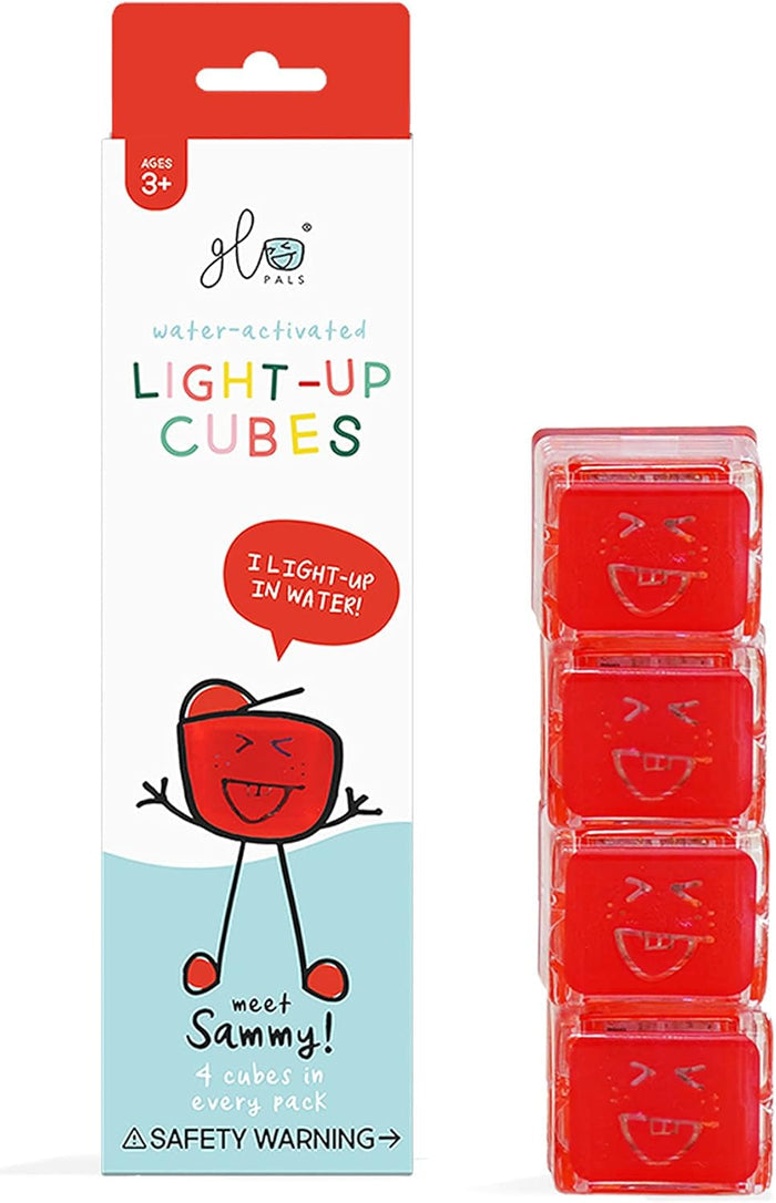 Red and white Glo Pals packaging next to a stack of four red, translucent water-activated cubes with smiling faces.