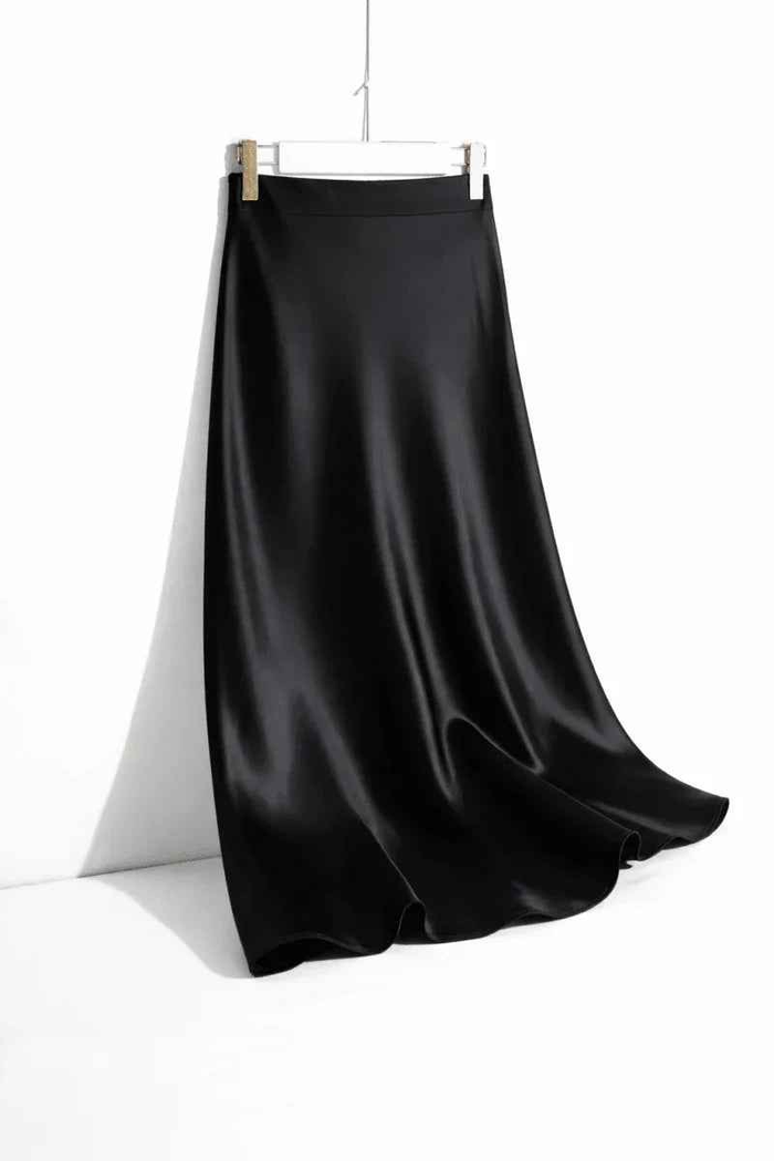 Stylish 3Sixty5 black satin straight skirt with a sleek design, perfect for elegant or casual wear.