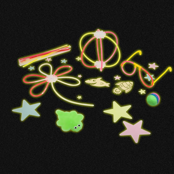 Neon glow-in-the-dark toys: stars, rocket, shark, glasses, flower, and sphere shapes glowing on a black background.