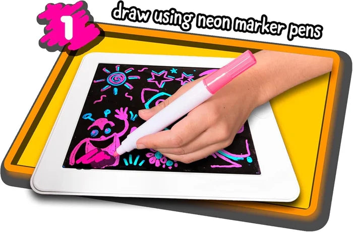 Hand drawing glowing neon figures on a white tablet's black screen with a pink marker pen.