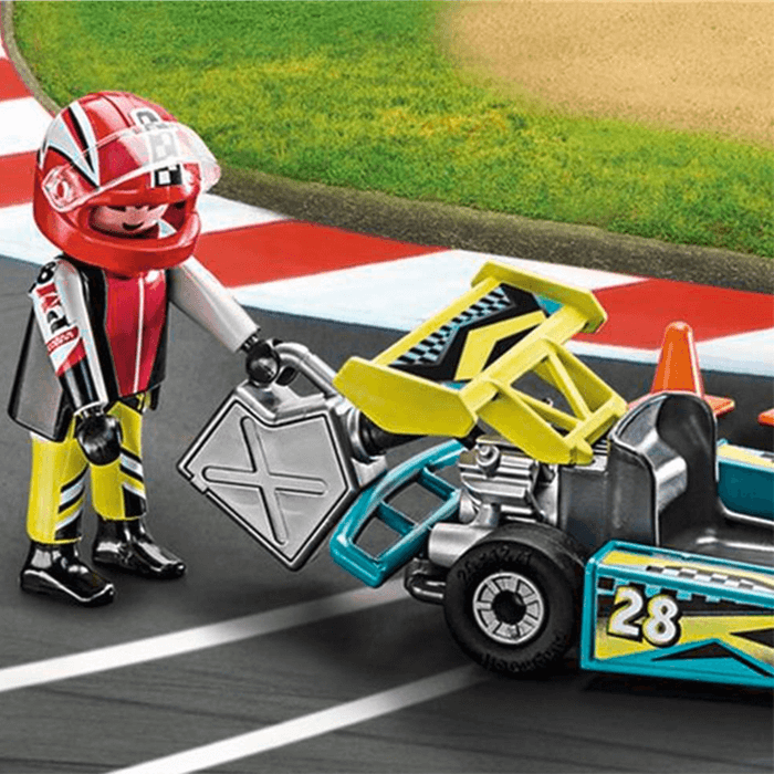 Toy racer in a red helmet fuels a blue and yellow number 28 go-kart with a silver gas can on a racetrack.