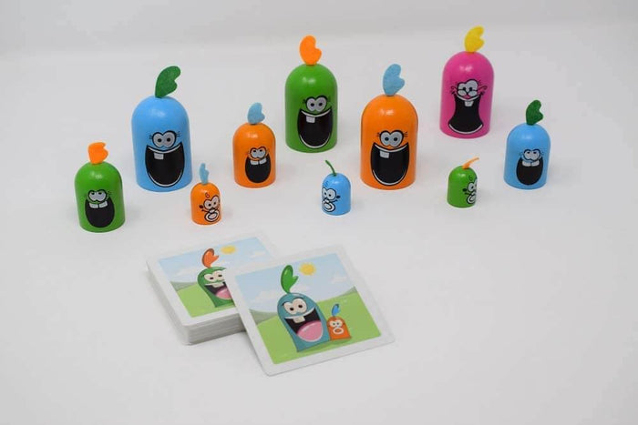 Colorful cylindrical figures with large open mouths and top tufts, shown with a deck of illustrated game cards.