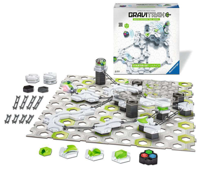 Built white and neon green marble run with silver tracks on a grey baseplate, next to the product packaging.