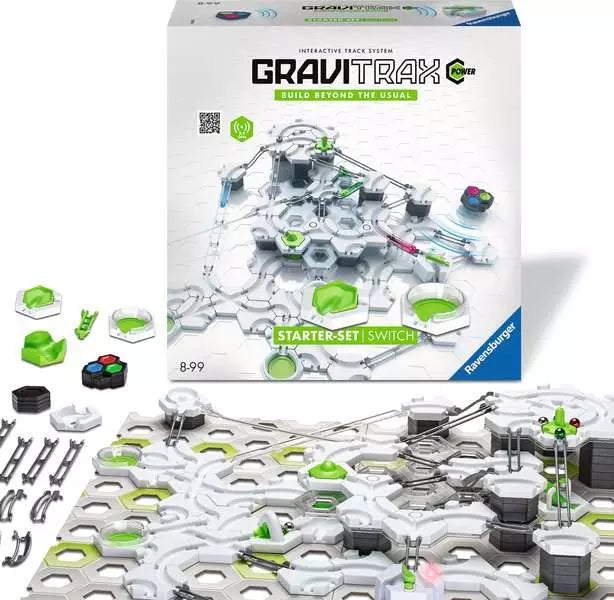 White box and built multi-level marble run with white hexagonal tracks, green accents, and silver marbles on grey bases.