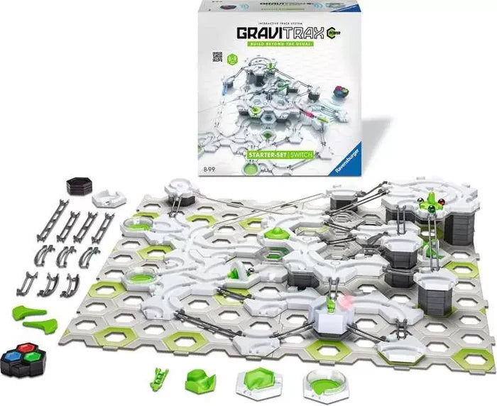 White and green marble run toy featuring hexagonal base plates, tracks, and motorized parts, shown with the box.