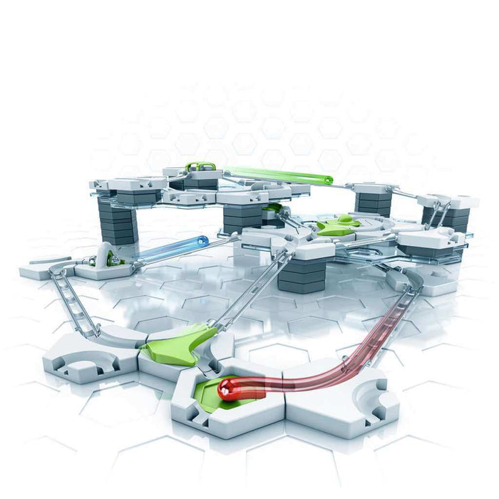 Multi-level marble run with white hexagonal plates, grey blocks, green pieces, and a red marble on transparent tracks.