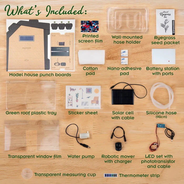 Kit components including cardboard punch boards, a solar panel, water pump, and grass seeds on a light wood background.