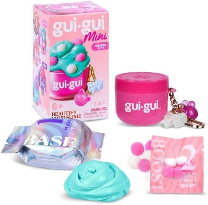 Pink slime kit with jar keychain, charms, blue glossy slime swirl, iridescent base packet, and pink pom-pom boost pack.