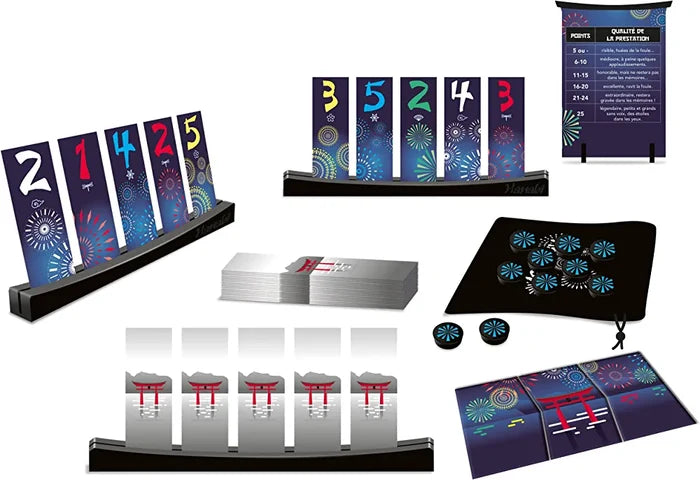 Firework-themed cards in wooden stands, silver card deck, blue tokens in a black bag, and scoring banner.